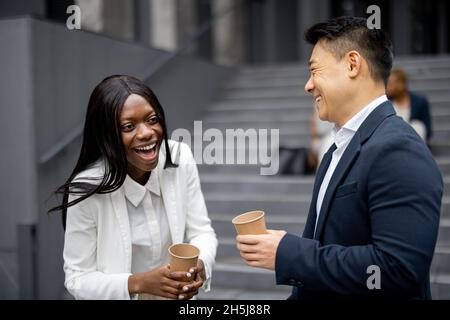 Business people eat on background of colleagues Stock Photo