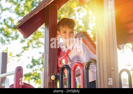 Green-eyed boy smiling while playing in a playground Stock Photo - Alamy