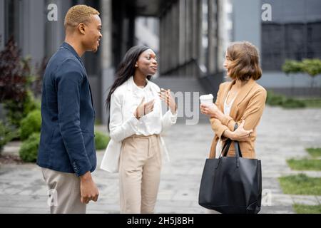 Multiracial business team talking on city street Stock Photo