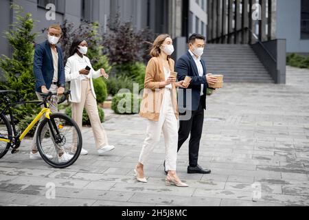 Business team in medical masks walking and talking Stock Photo