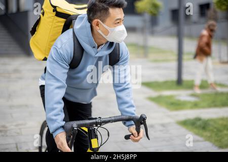 Courier search client place on smartphone in city Stock Photo