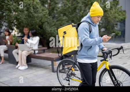 Courier search client place on smartphone in city Stock Photo