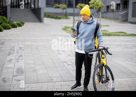 Courier search client place on smartphone in city Stock Photo