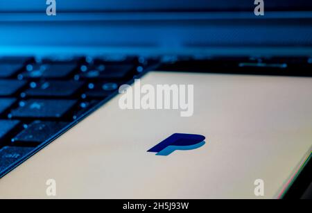 smartphone on a computer keyboard with the Paypal app logo Stock Photo