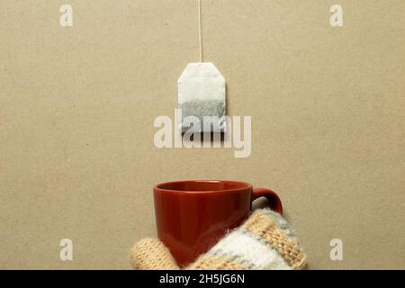 Tea bag and mug cup on brown background. winter concept. top view, copy space Stock Photo