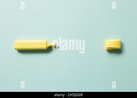 Yellow highlighter pen isolated on blue background. top view, copy space Stock Photo
