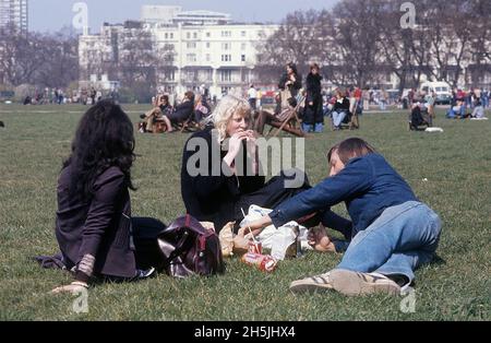 London 1982. A London park and people having a meal. It's a sunny spring day and people in the background are sitting in the sun. Credit Roland Palm. Stock Photo
