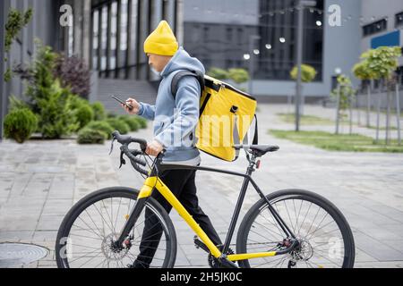 Courier search client place on smartphone in city Stock Photo