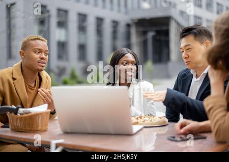 Business team having lunch at outdoor cafe Stock Photo