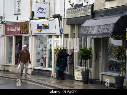 People make their way along Brook street in Tavistock, Devon, in the Torridge and West Devon constituency of former Cabinet minister Sir Geoffrey Cox, who could face an investigation by the Commons standards tsar over claims he 'broke the rules' by using his parliamentary office for his second job offering legal advice. The former attorney general has said he does not believe he has breached parliamentary rules after a video emerged appearing to show him undertaking external work advising the British Virgin Islands in a corruption probe launched by the Foreign Office. Picture date: Wednesday N Stock Photo