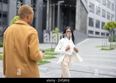 Man taking photo on smartphone of his girlfriend Stock Photo