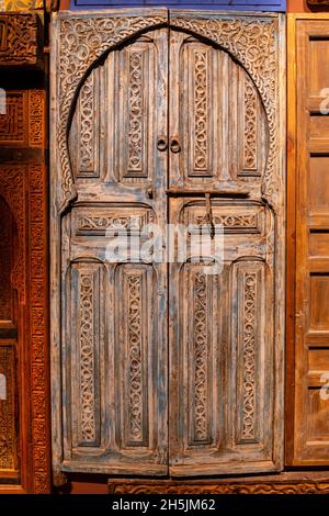 Arabic style wooden carved doors with arch and carved ornaments in Moroccan Pavilion at Expo 2020 Dubai.