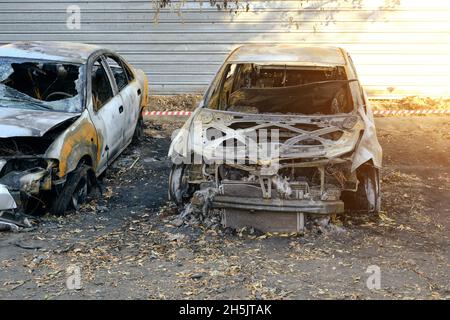 Skeletons of burnt out cars after severe fire. Arson, short circuit of the wiring Stock Photo