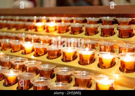 Rows of Candles Lit On Alter Stock Photo