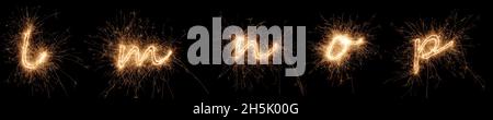 golden bright sparkler alphabet font letter set collection part L to P isolated on dark black background. silvester new year birthday and celebration Stock Photo