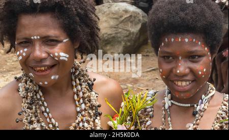 Young women with traditional face painting and seashell accessories in Natade Village in Tufi on the Cape Nelson peninsula, Oro Province, Papua New... Stock Photo