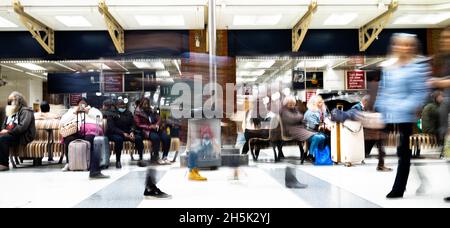 A blur of passengers at the busy mainline Liverpool Street Railway Station in London. Liverpool St serves trains to Eastern England. Stock Photo