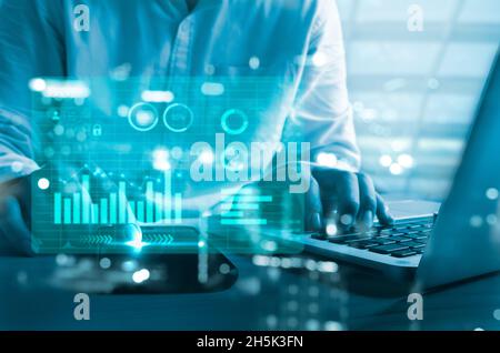 business chart and graph. Businessman using computer laptop and smart phone virtual hologram. business technology concept Stock Photo