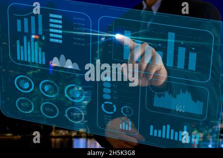 business chart and graph. Businessman touching virtual screen hologram. business technology concept Stock Photo