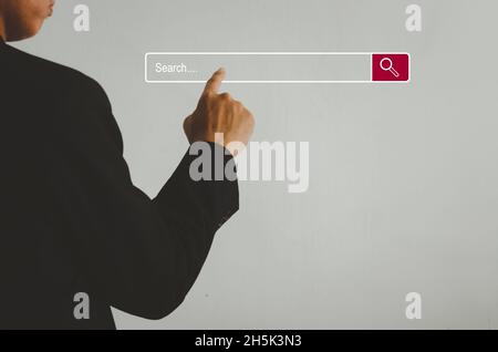 Businessman is touching a search on a virtual screen.Searching information network concept with copy space. internet search page computer touch screen Stock Photo