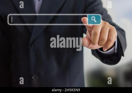 Businessman is touching a search on a virtual screen.Searching information network concept with copy space. internet search page computer touch screen Stock Photo