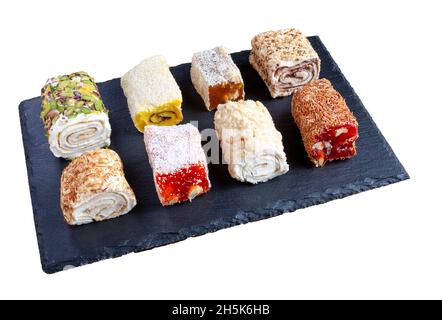 Turkish delight. Set of assorted Turkish delights with various flavors cream-filled. Lokum rolls covered nuts and sugar powder. Fruit jelly candy with Stock Photo