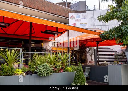 Kingston Upon Thames London England UK November 5 2021, Restaurant Open Air Terrace Eating Area With Orange Canopies And Heaters With No People Stock Photo