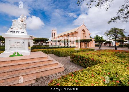 Church of St Francis of Assisi, rebuilt in 1932, with the Church Square and War Memorial in the foreground in the town of Saint Francois, Grande-Terre Stock Photo