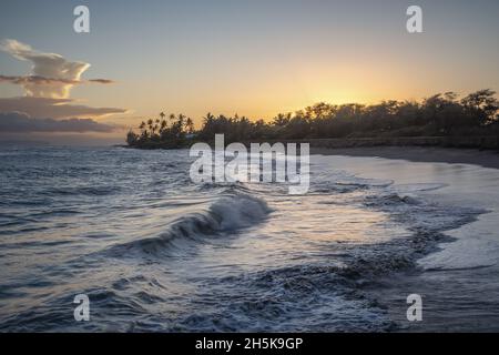 Waves rolling onto the beach at 'O'Omano Point along the Na Pali Coast at sunset; Kekaha, Kauai, Hawaii, United States of America Stock Photo