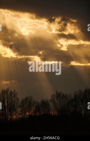 Rays of sunshine coming through dark clouds; Bavaria, Germany Stock Photo