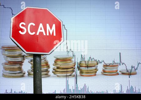 Scam stop road sign on economy background with graph and coins. Be aware of scam sign. Stock Photo