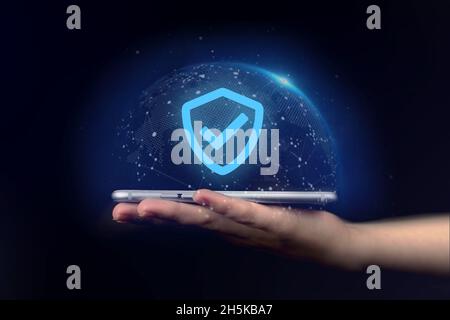 Data protection, privacy information. Hand holding mobile phone with shield. Cyber security network, internet technology concept Stock Photo