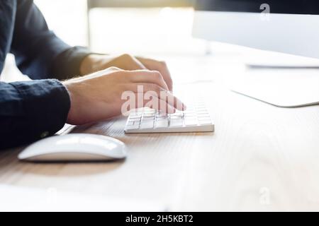 Cropped view of programmer using computer keyboard in office Stock Photo