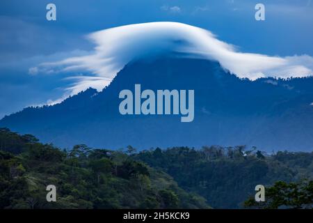 Cloud formation over the hills above Tufi fjord on the Cape Nelson peninsula, Oro Province, Papua New Guinea; Tufi, Oro Province, Papua New Guinea Stock Photo