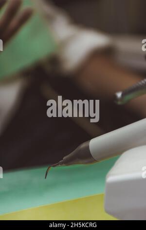 Modern tools for dental cleaning in a dental clinic with a patient in the background Stock Photo