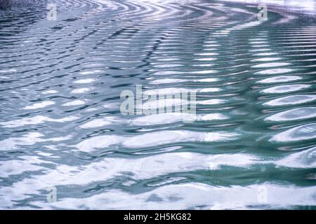 Reflections on the blue ripples of the calm waters of Glacier Bay; Glacier Bay National Park, Alaska, United States of America Stock Photo
