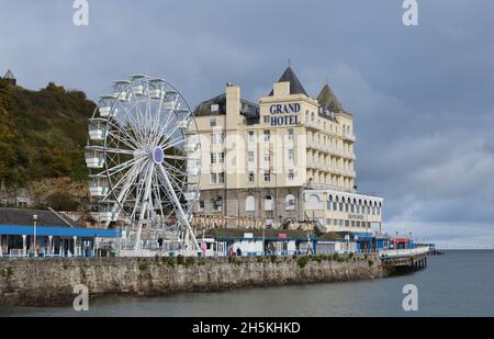 Ferris Wheel on the Pier at Llandudno in front of the Grand Hotel which originally opened in 1902 Stock Photo