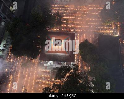 NOVMBER 06,2021,DHAKA,BANGLADESH-Thousands of Hindu devotees sit with Prodip and pray to God in front of Shri Shri Lokanath Brahmachari Ashram temple Stock Photo