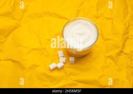 https://l450v.alamy.com/450v/2h5km5f/sugar-in-glass-bowl-on-yellow-background-diabetes-and-unhealthy-diet-concept-2h5km5f.jpg