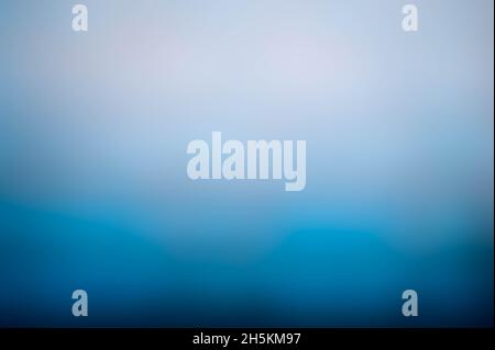 Dark blue bottom fading to white at the top, soft blue glow Stock Photo