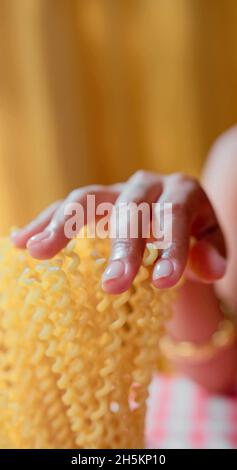 A woman is touching pasta Stock Photo