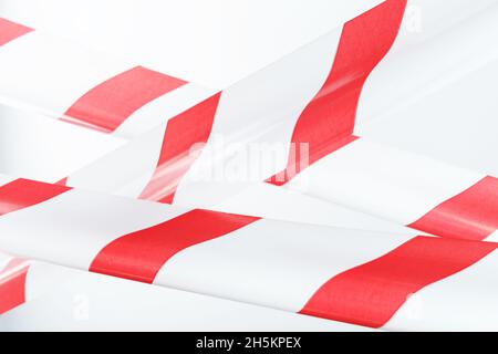 Red and white striped fencing tape on a white background. Tapes for fencing and highlighting danger Stock Photo