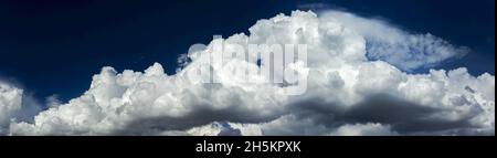 Panorama of dramatic storm clouds with blue sky in the background; Calgary, Alberta, Canada Stock Photo