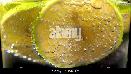 Focus on bubbles on a lemon in a glass Stock Photo