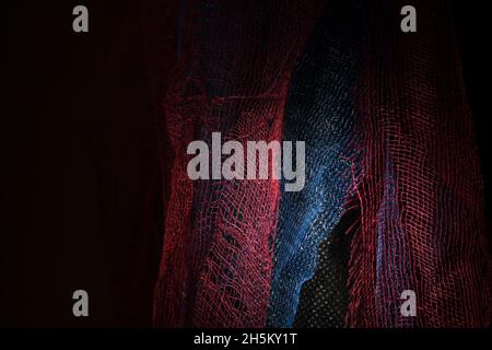 Red cloth in the dark close up, background or texture Stock Photo