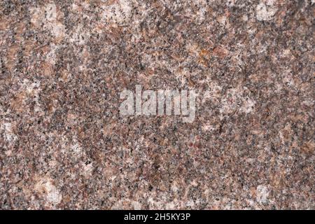 pink and black textured raw masonry rock marble stone close Stock Photo