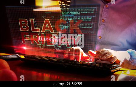 Black Friday on computer screen. Big sale, hot deal, shopping and special offer abstract concept 3d with glitch effect. Man typing keyboard. Stock Photo
