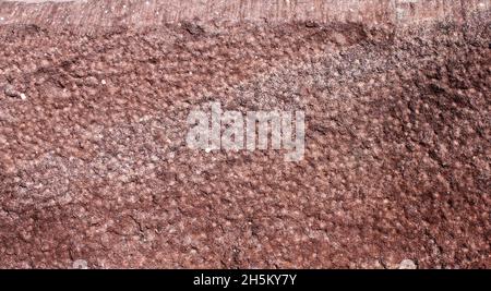 close up of a red and brown irregularly patterned sandstone surface Stock Photo