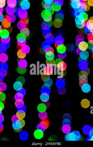 Colored blurred lights, defocused background. New Year Christmas background with multicolored blurred lights. Stock Photo