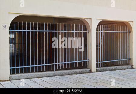 The passage under the house is fenced with a metal fence Stock Photo
